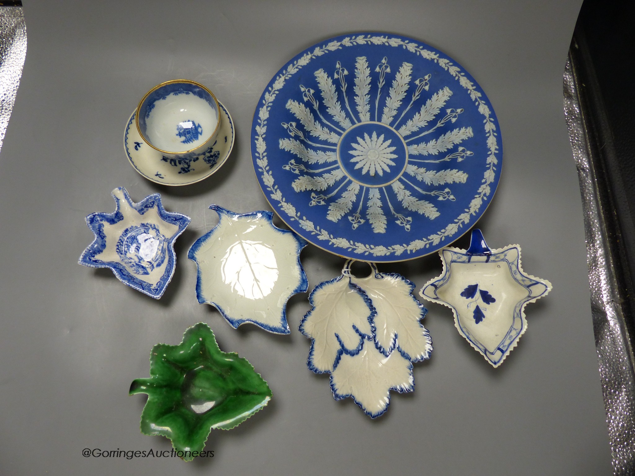 A 19th century Wedgwood blue jasper dish in classical style, five leaf dishes, a blue painted creamware saucer and a blue printed teabowl